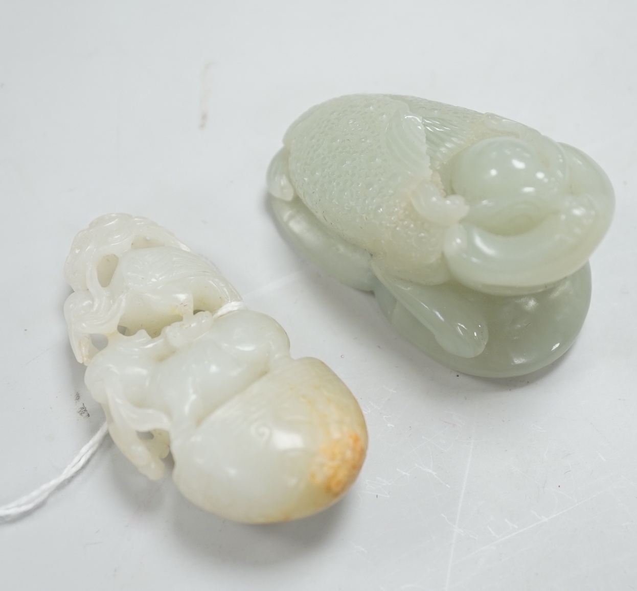 A Chinese green jade figure of a three legged toad and a Chinese pale celadon jade group of a crane and a deer in archaic style, toad carving 6.5cm long (2)